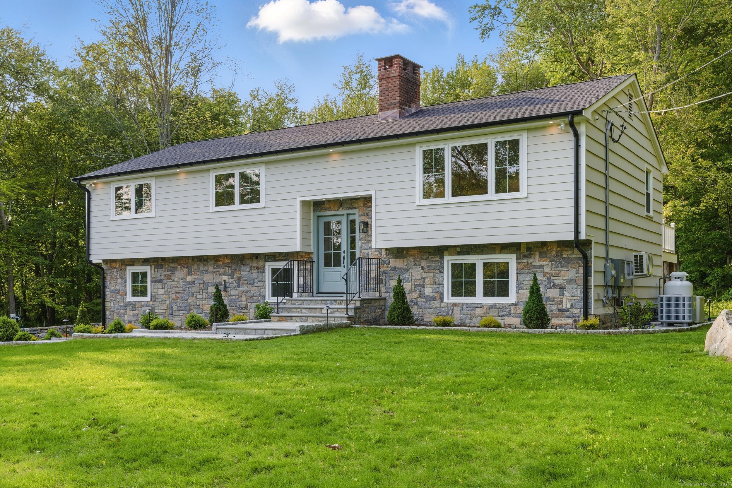 a front view of house with yard and outdoor seating