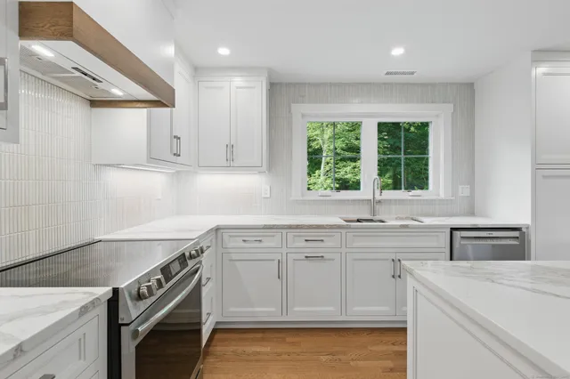 a kitchen with a sink stove and cabinets