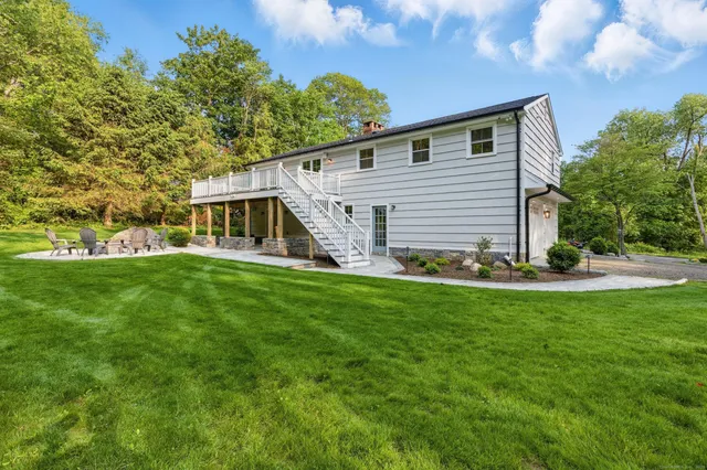 a front view of house with yard and green space
