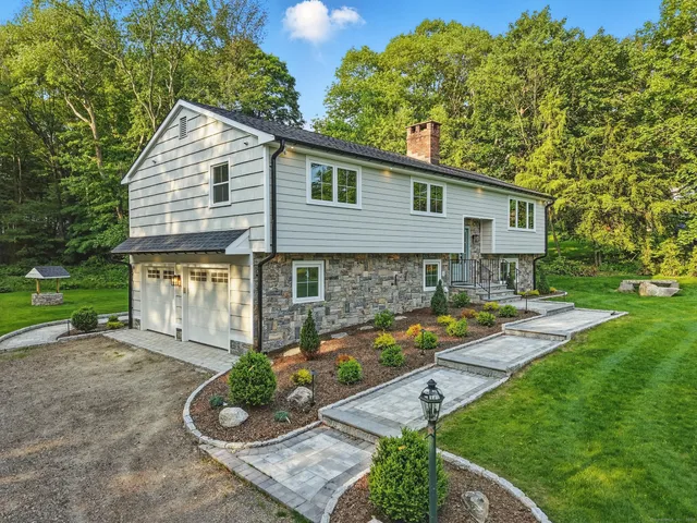 a front view of a house with garden