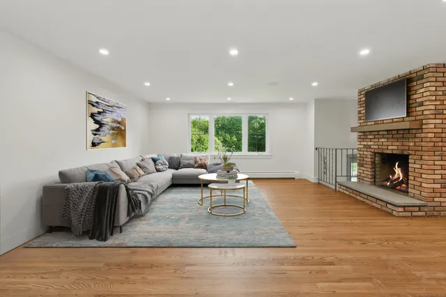 a living room with furniture a window and a fireplace