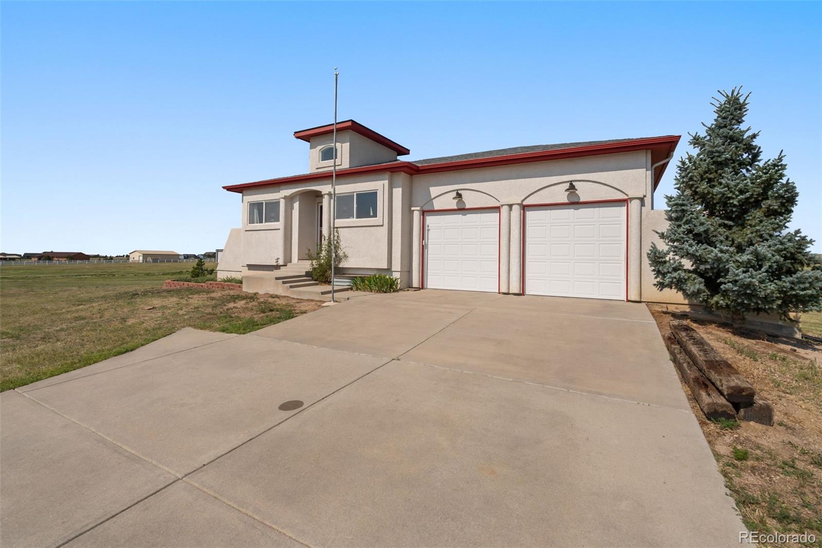11424 McKissick Road Peyton, CO 80831 - Photo 1 of 32 a front view of a house with yard