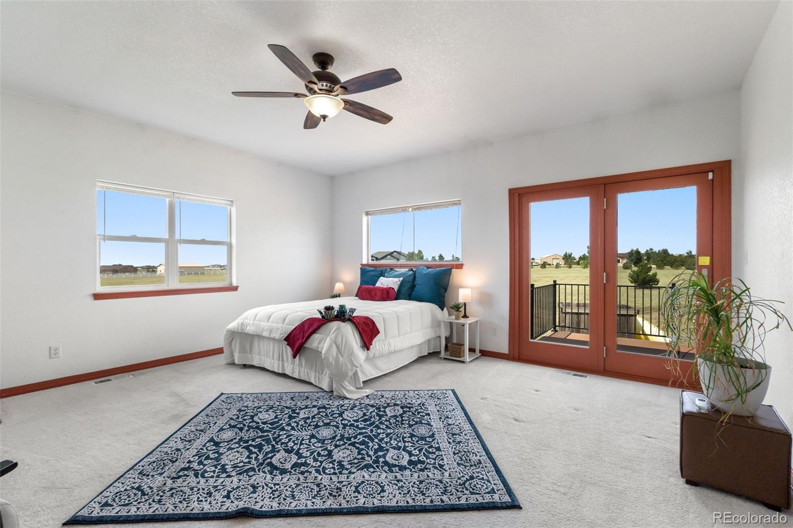 11424 McKissick Road Peyton, CO 80831 - Photo 12 of 32 a bedroom with a large bed and a couch