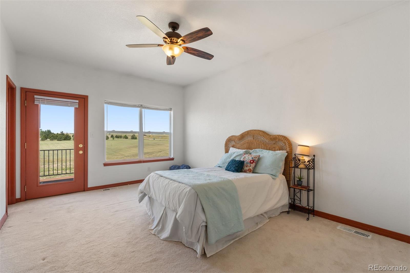 11424 McKissick Road Peyton, CO 80831 - Photo 16 of 32 a spacious bedroom with a bed and a window