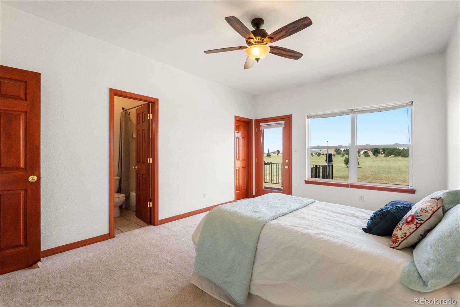 11424 McKissick Road Peyton, CO 80831 - Photo 17 of 32 a bedroom with a large bed and a window