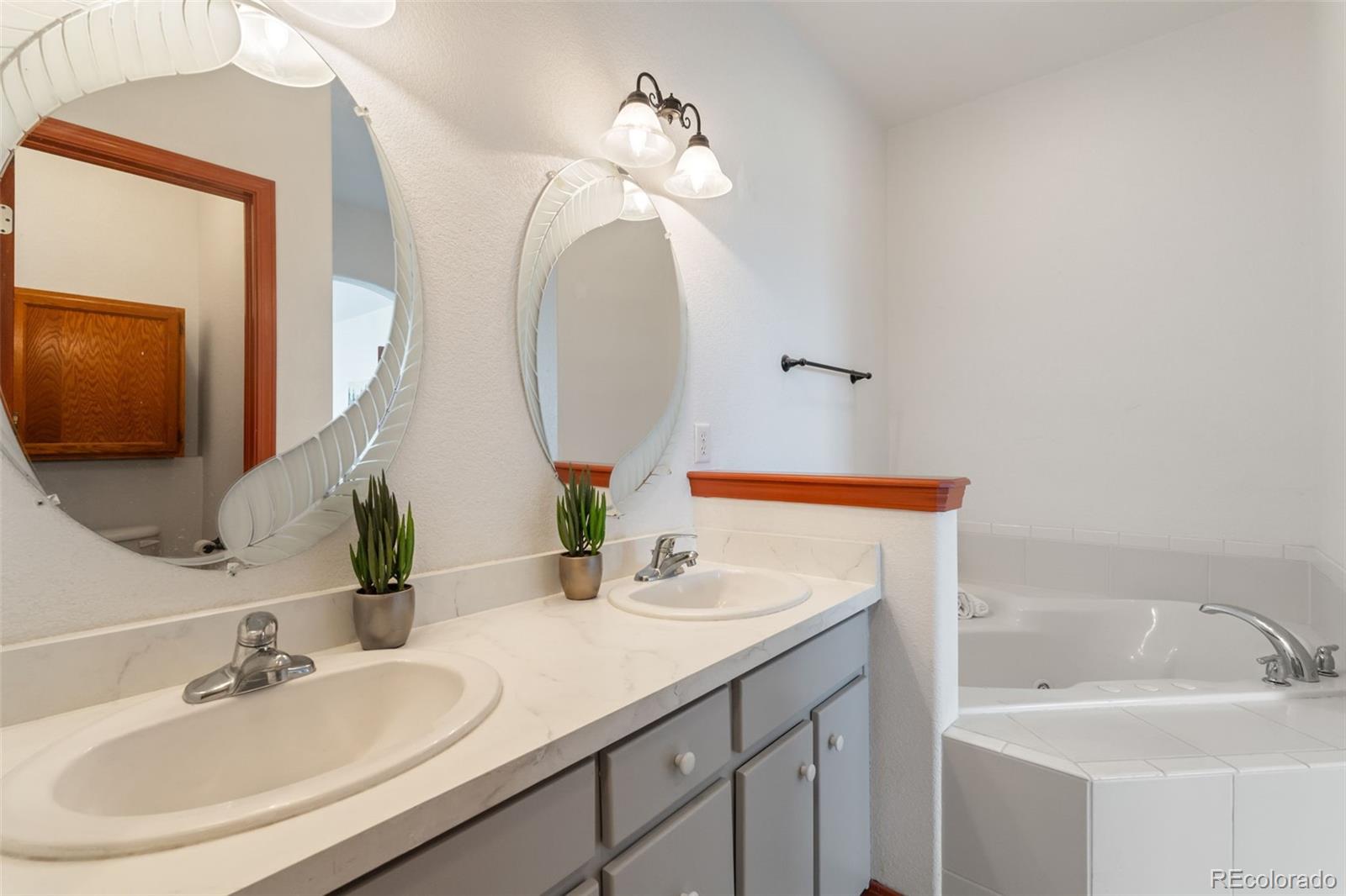 11424 McKissick Road Peyton, CO 80831 - Photo 19 of 32 a bathroom with a sink and a mirror
