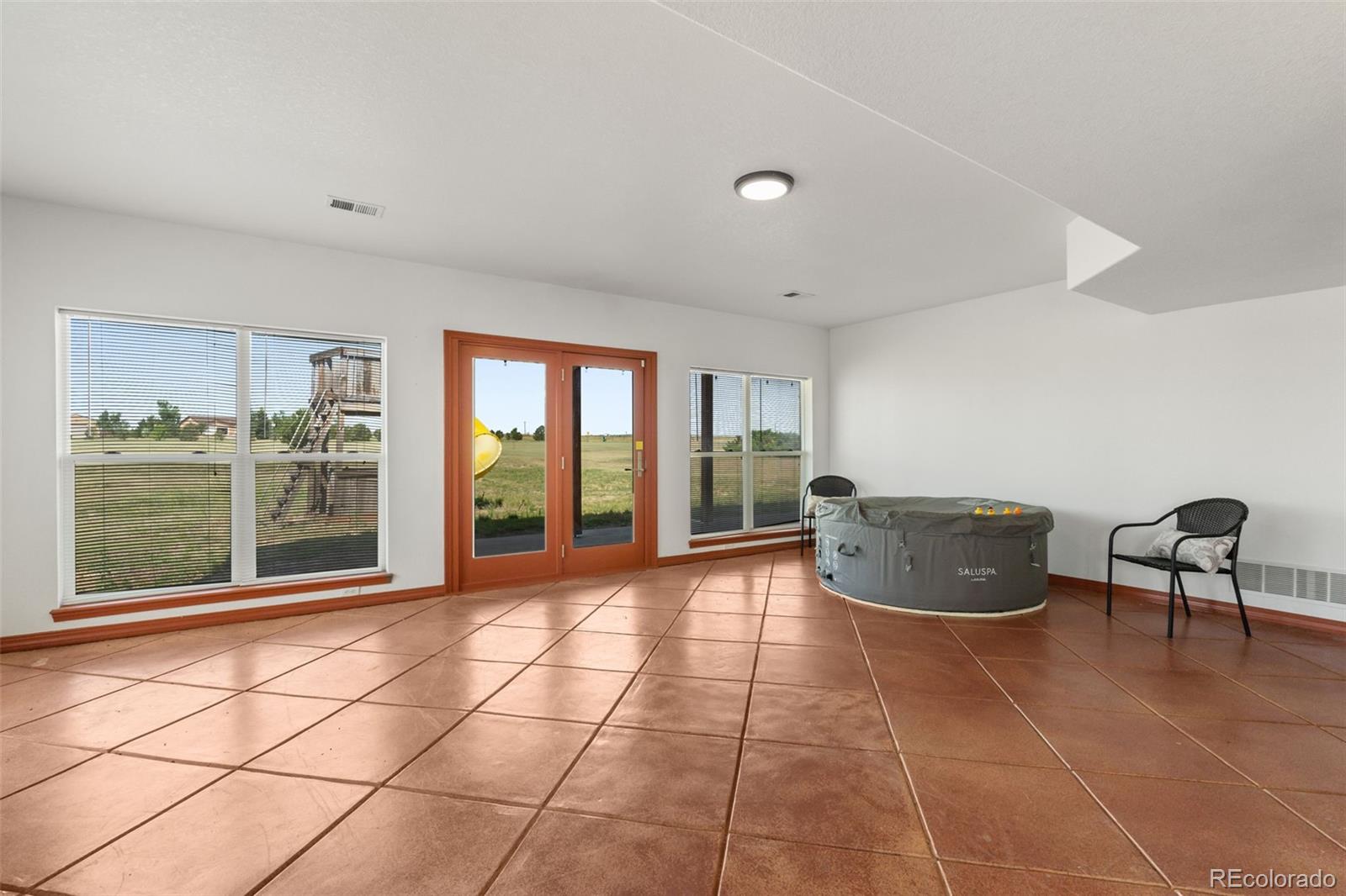 11424 McKissick Road Peyton, CO 80831 - Photo 21 of 32 a room with gym equipment and large windows
