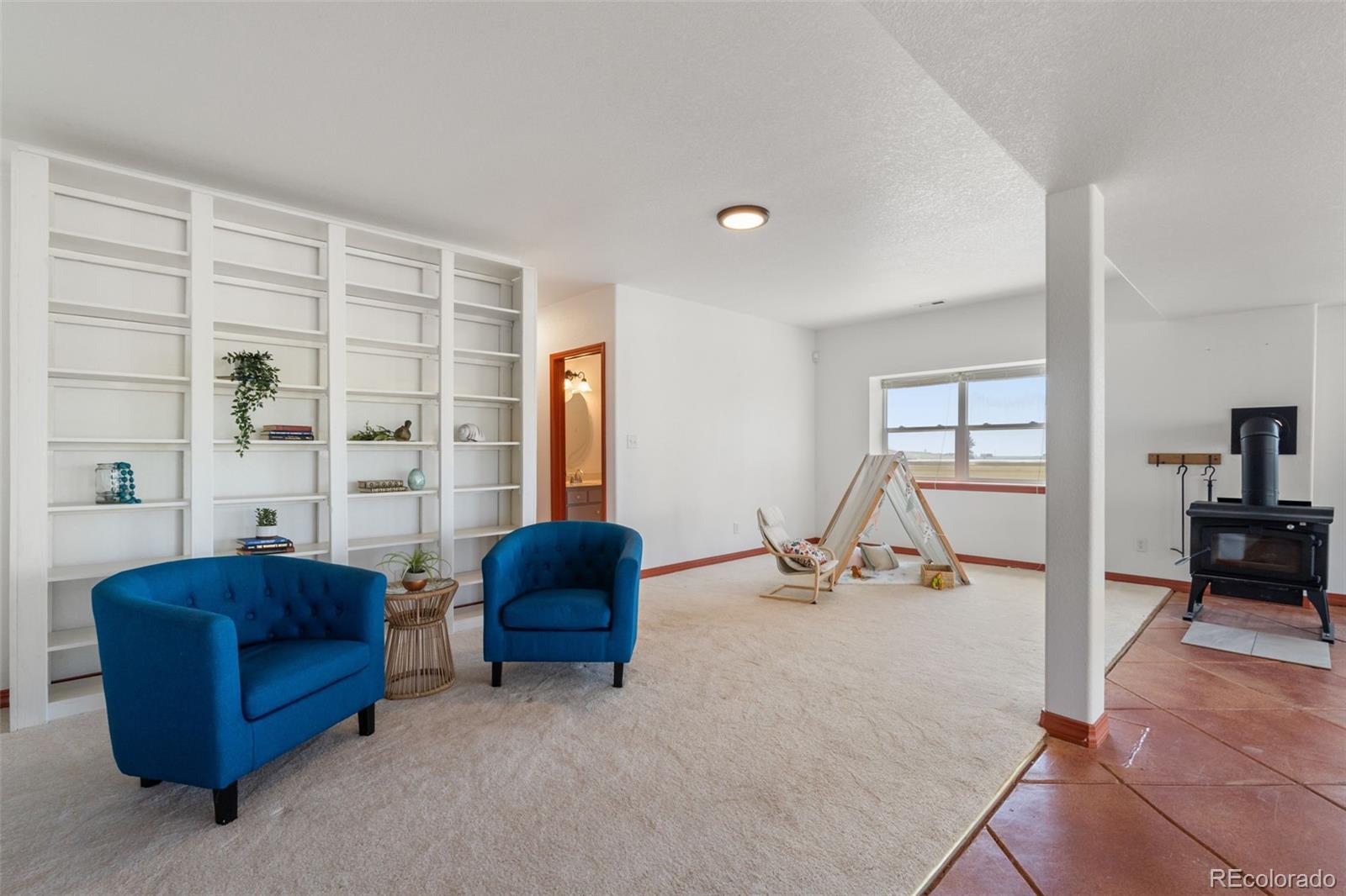 11424 McKissick Road Peyton, CO 80831 - Photo 24 of 32 a living room with furniture and a large window