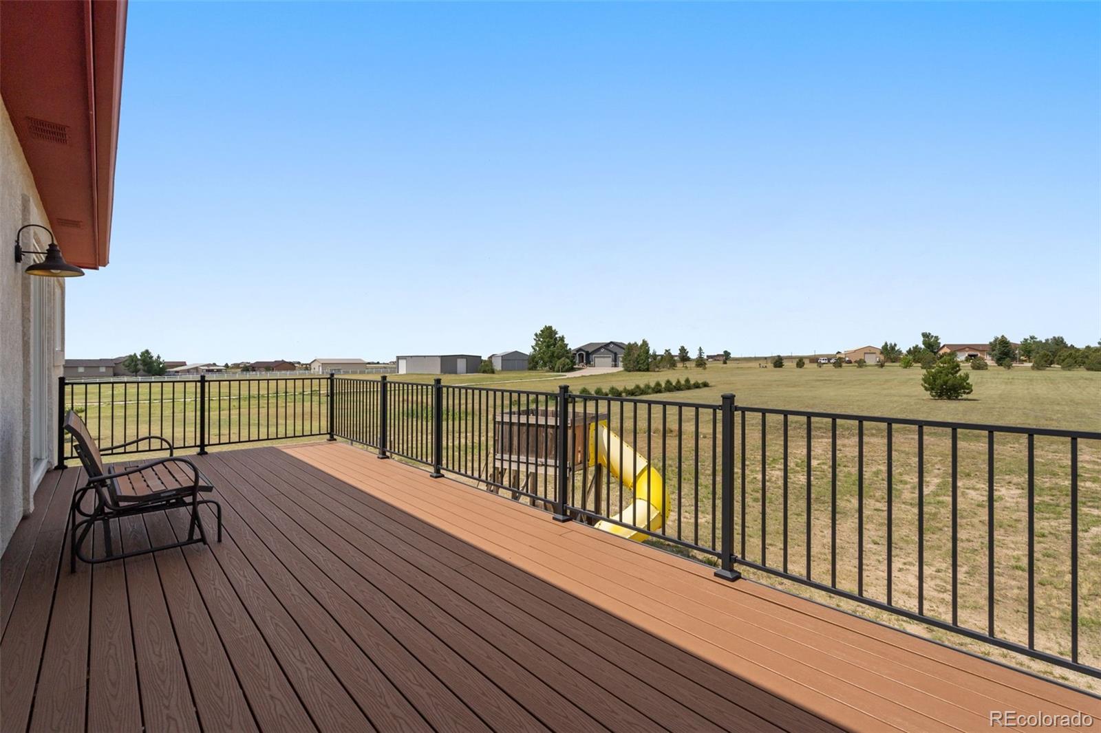11424 McKissick Road Peyton, CO 80831 - Photo 27 of 32 a view of a balcony with wooden floor space