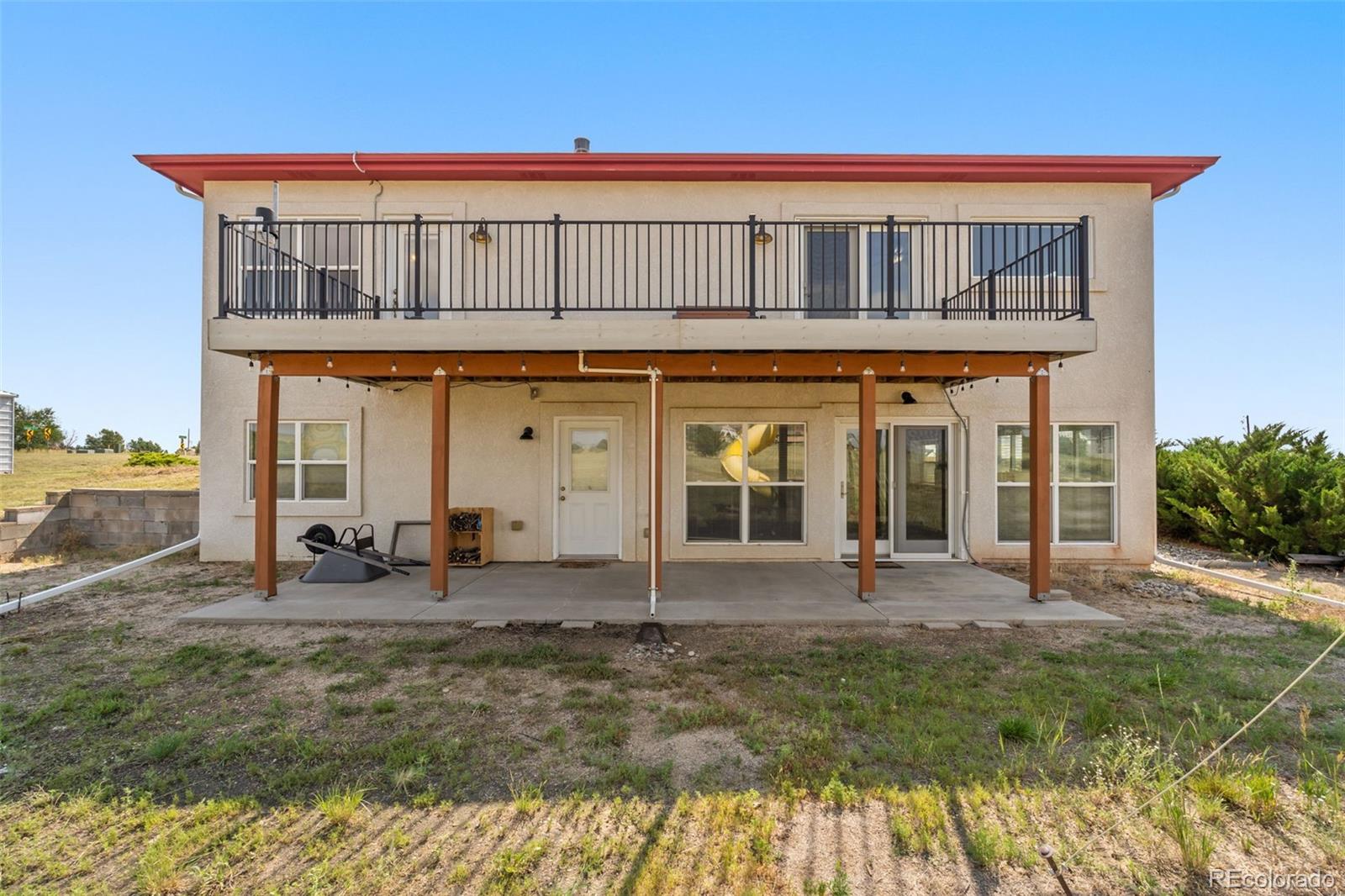 11424 McKissick Road Peyton, CO 80831 - Photo 28 of 32 a front view of a house with garden