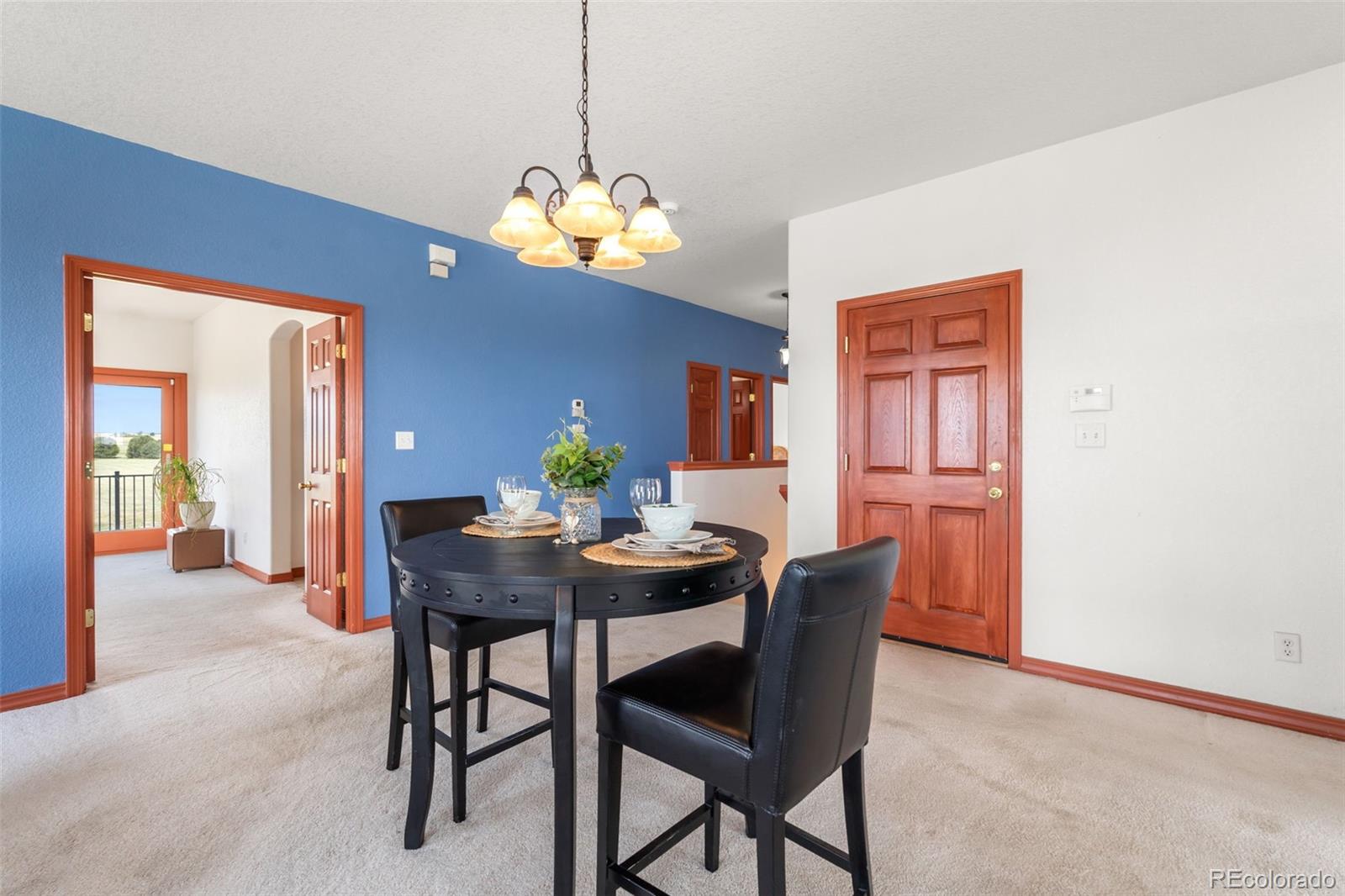 11424 McKissick Road Peyton, CO 80831 - Photo 3 of 32 a view of a dining room with a table and chairs