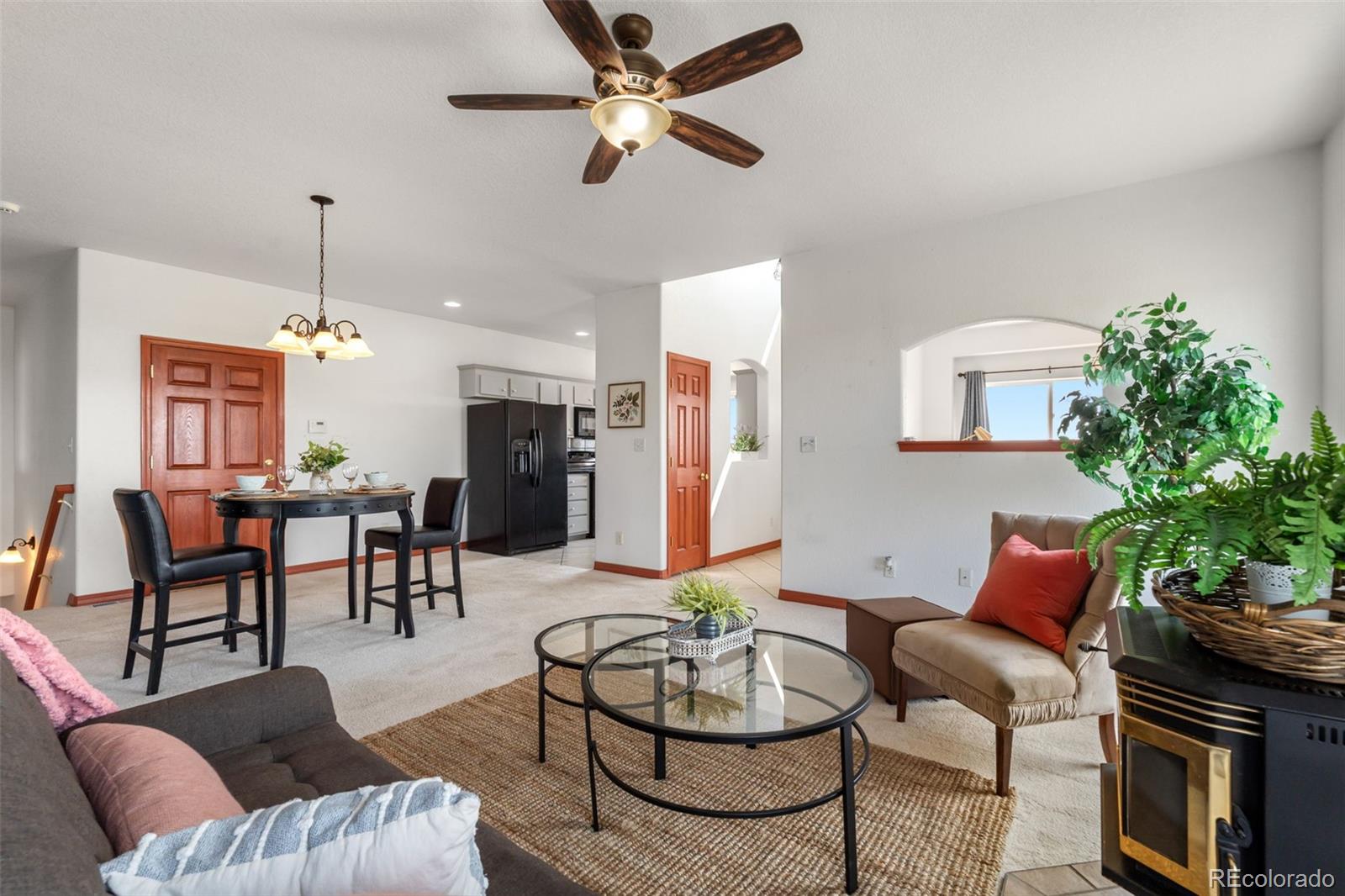 11424 McKissick Road Peyton, CO 80831 - Photo 6 of 32 a living room with furniture kitchen view and a chandelier