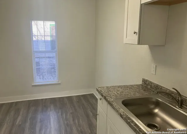 a kitchen with a sink and cabinets