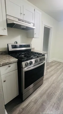 a stove top oven sitting inside of a kitchen