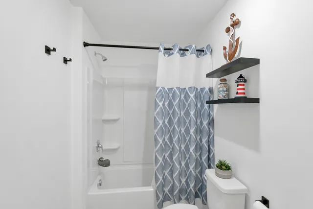 a bathroom with a bathtub and shower