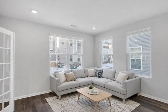a living room with furniture and windows