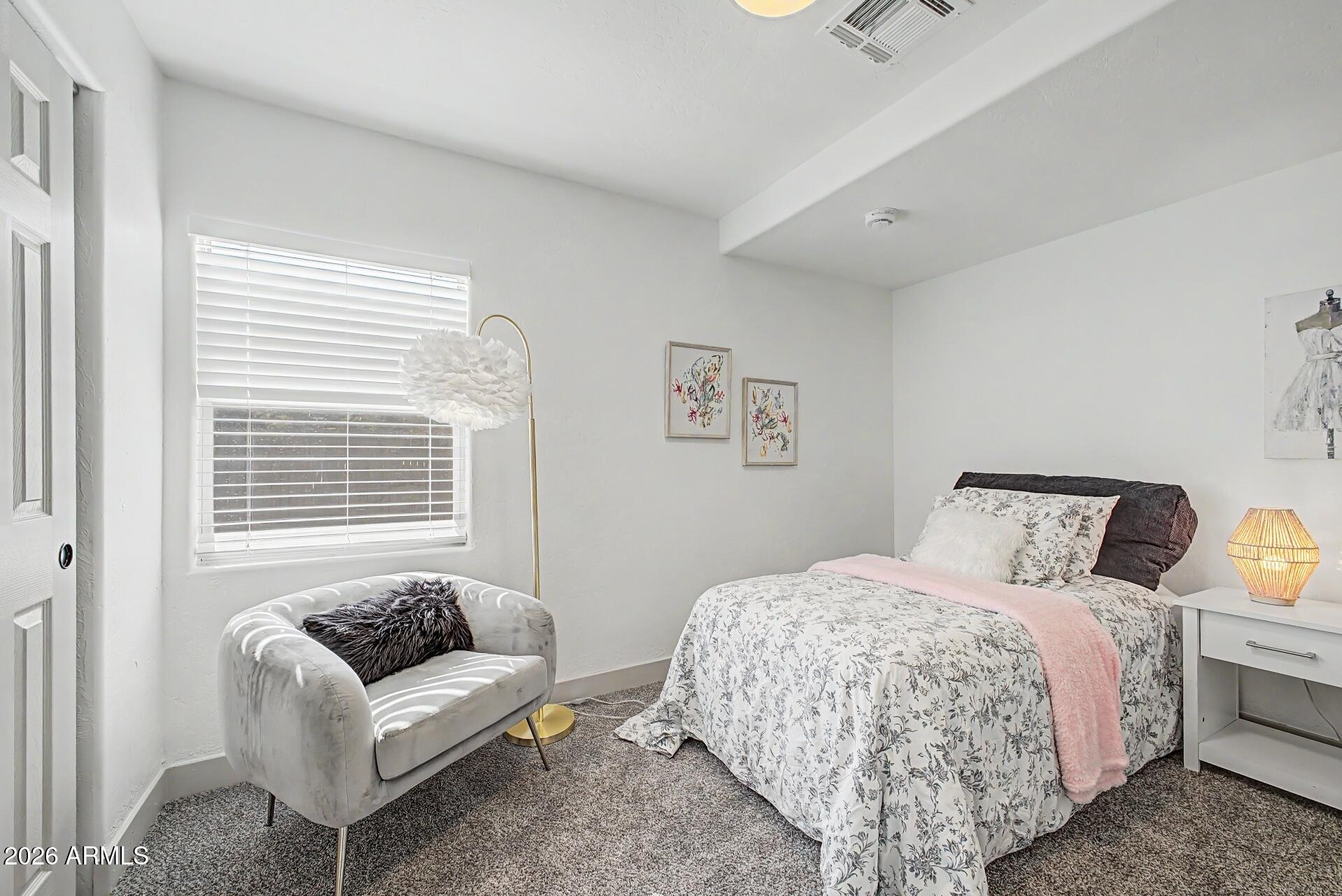 1914 East Monte Vista Road Phoenix, AZ 85006 - Photo 15 of 26 a bedroom with a bed and a couch