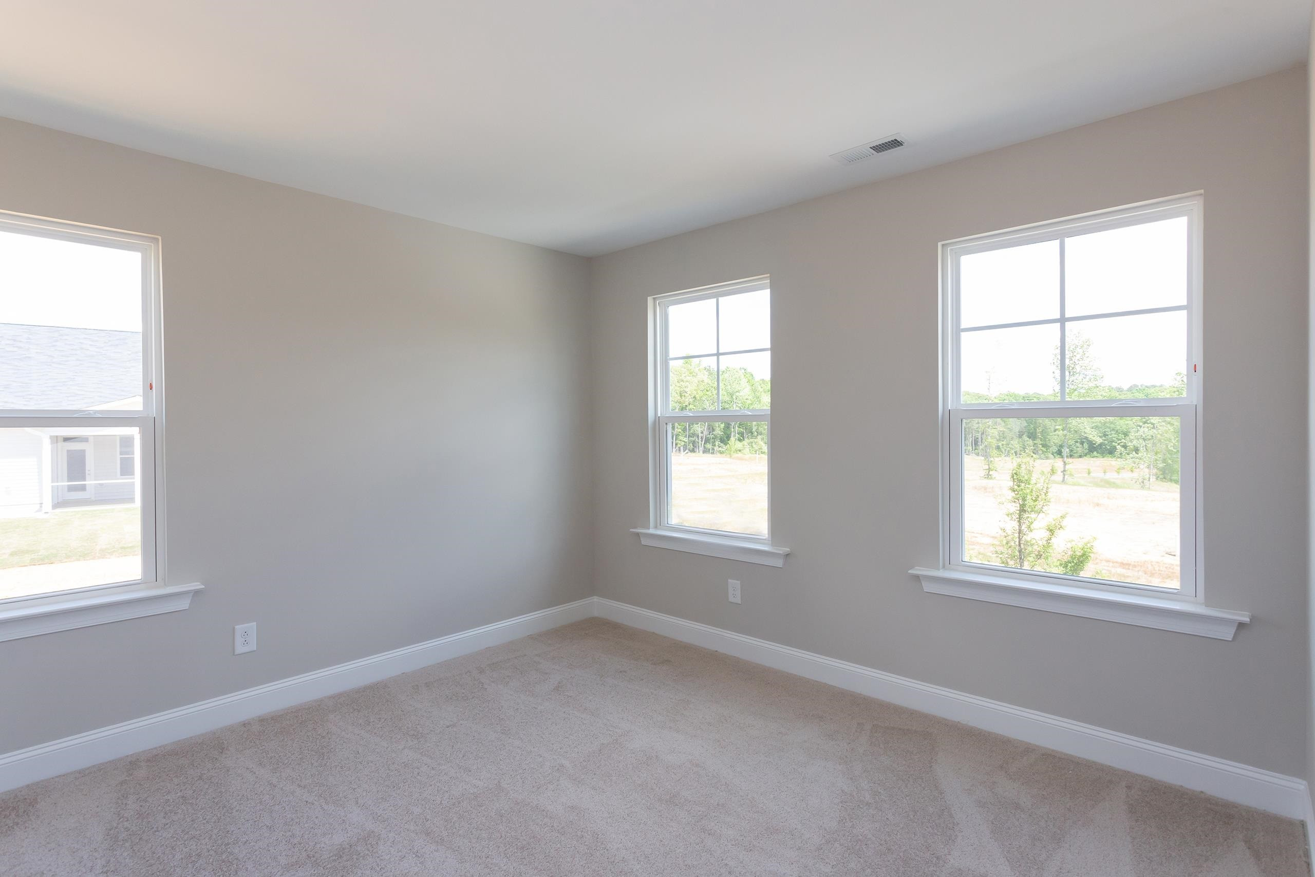 716 Virgil Road Durham, NC 27703 - Photo 3 of 14 an empty room with a window