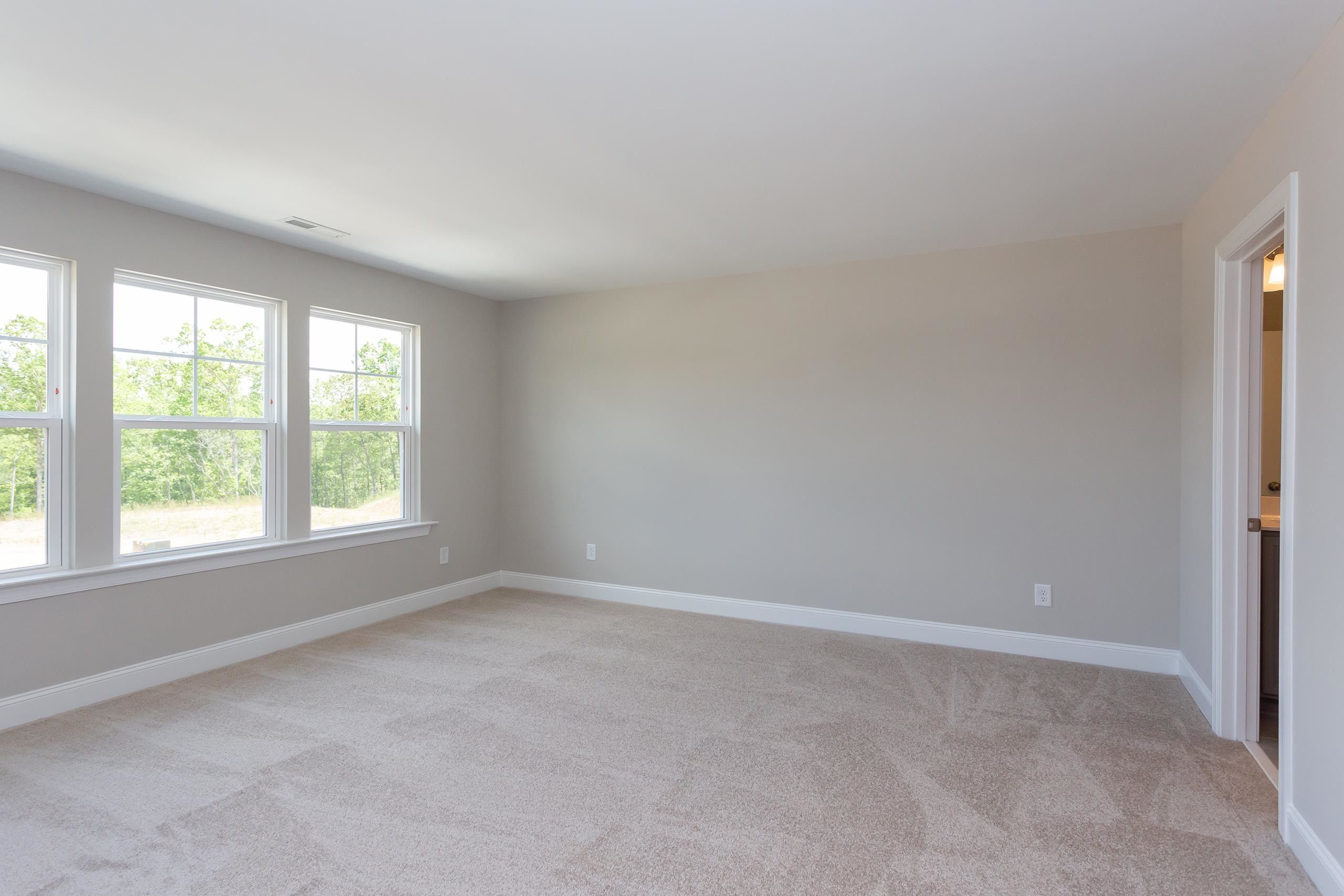 716 Virgil Road Durham, NC 27703 - Photo 5 of 14 an empty room with a window