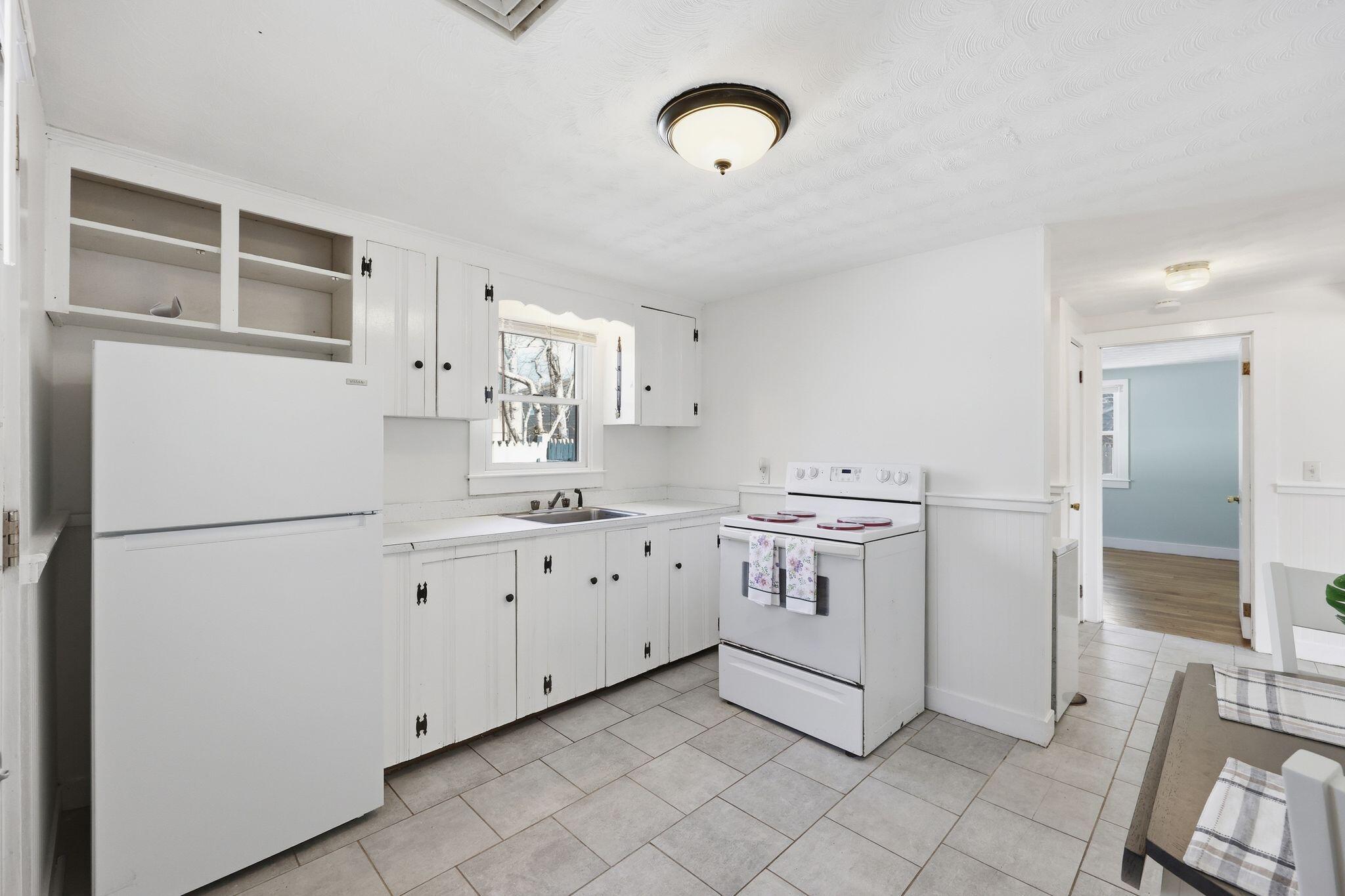 26 Howes Road South Yarmouth, MA 02664 - Photo 16 of 42 a kitchen with granite countertop cabinets and white appliances