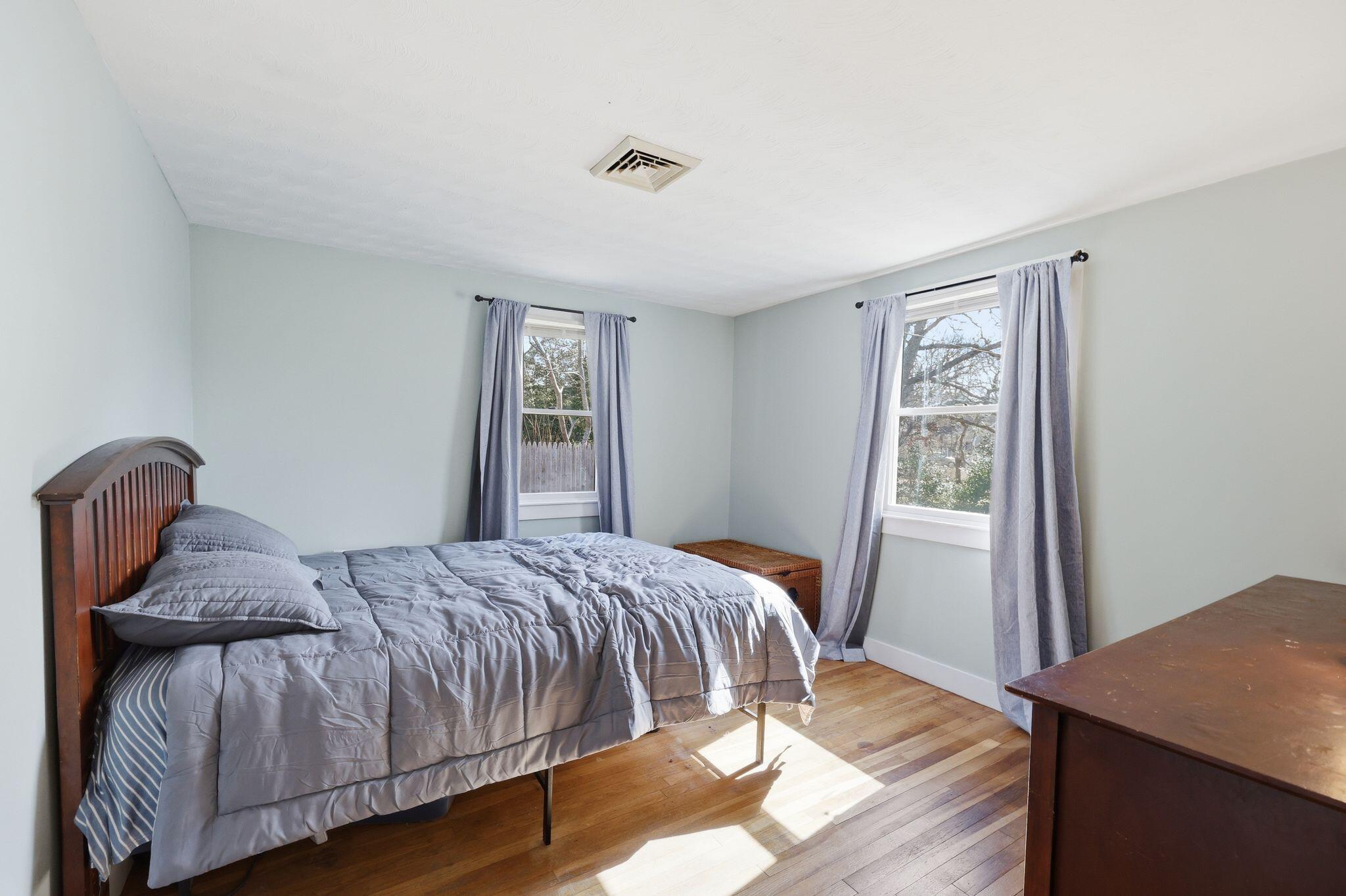 26 Howes Road South Yarmouth, MA 02664 - Photo 24 of 42 a bedroom with a bed and wooden floor