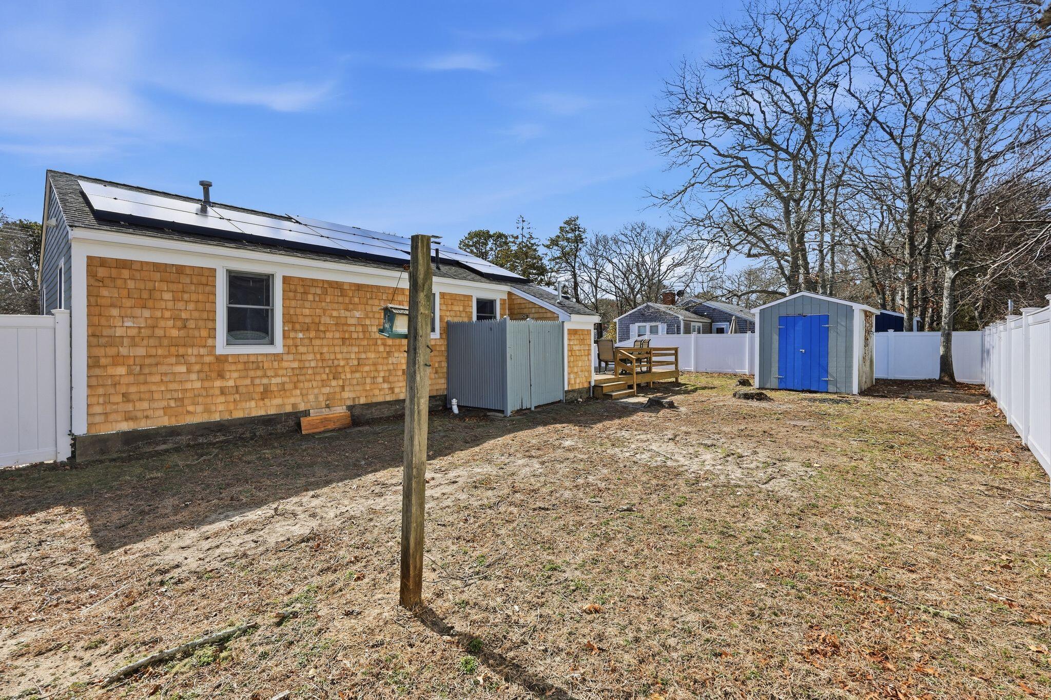 26 Howes Road South Yarmouth, MA 02664 - Photo 41 of 42 a front view of a house with a yard covered in snow