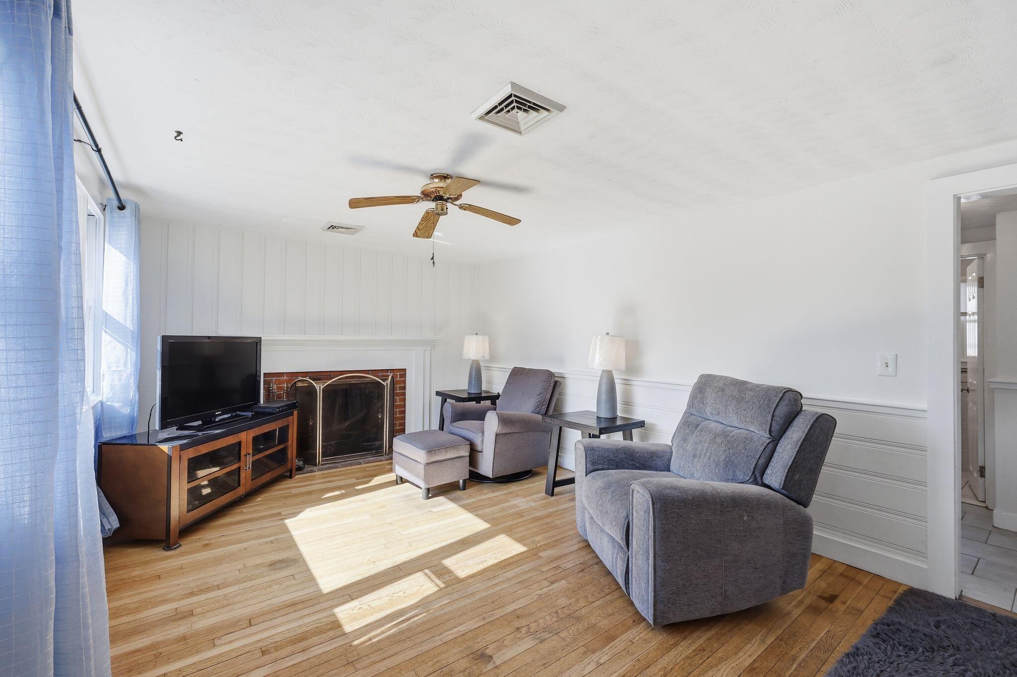 26 Howes Road South Yarmouth, MA 02664 - Photo 9 of 42 a living room with furniture a flat screen tv and a fireplace