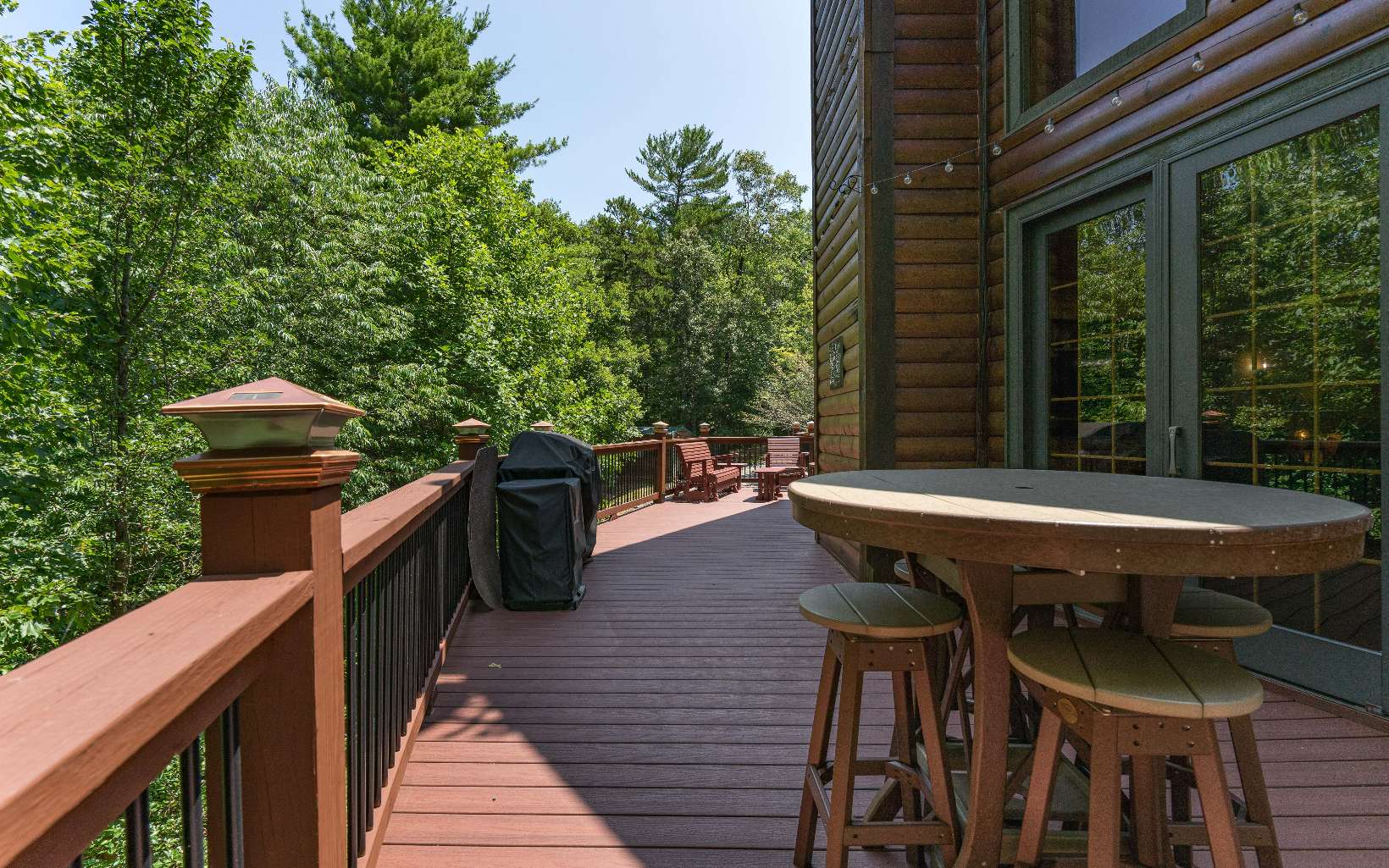 260 Berry Hl Road Murphy, NC 28906 - Photo 36 of 55 a view of a patio with table and chairs with wooden floor and fence
