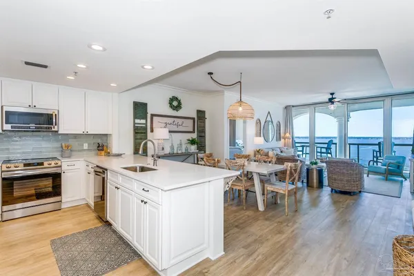 a kitchen with lots of counter top space and wooden floor