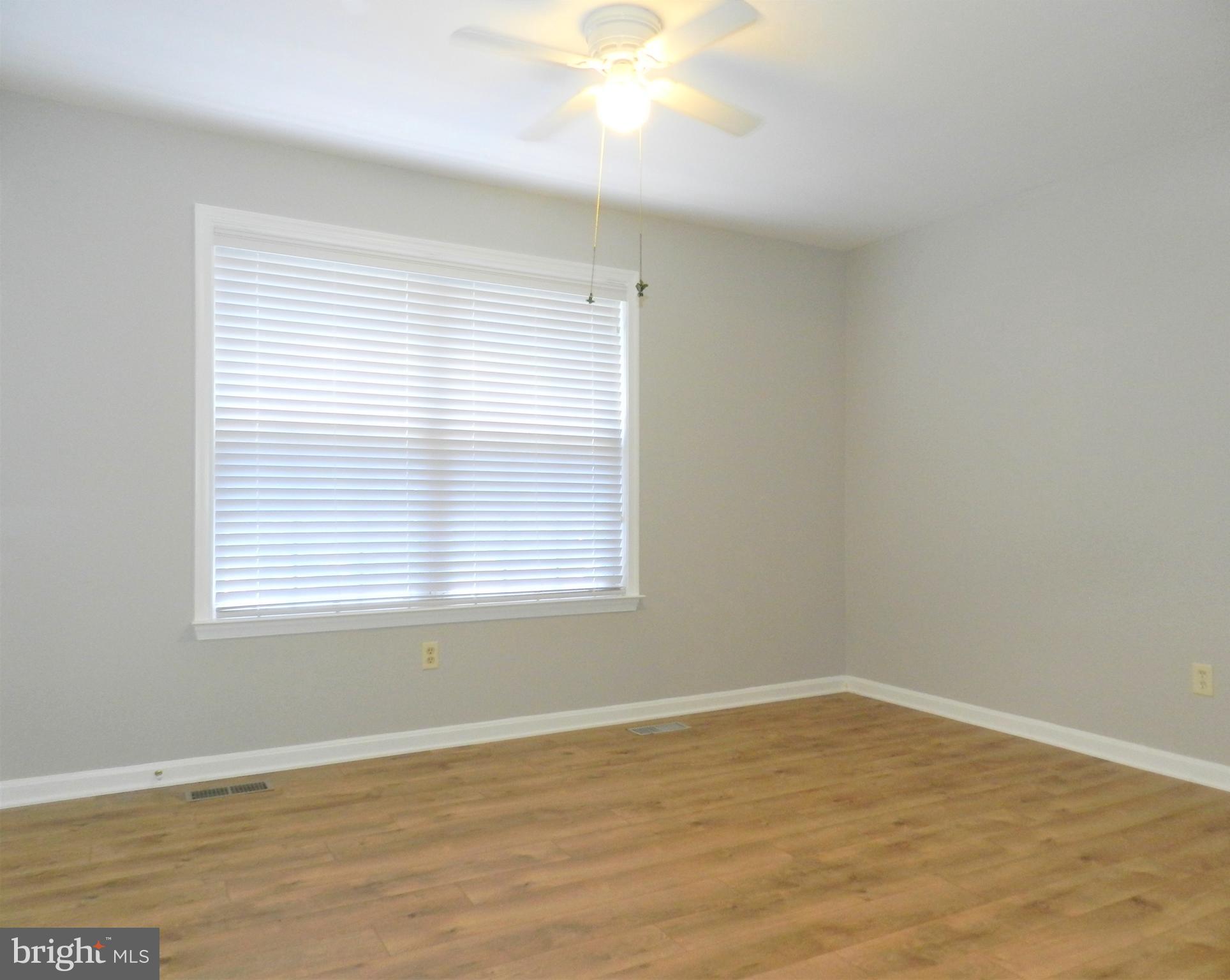 8650 Passapatanzy Road King George, VA 22485 - Photo 13 of 30 a view of an empty room with wooden floor and a window