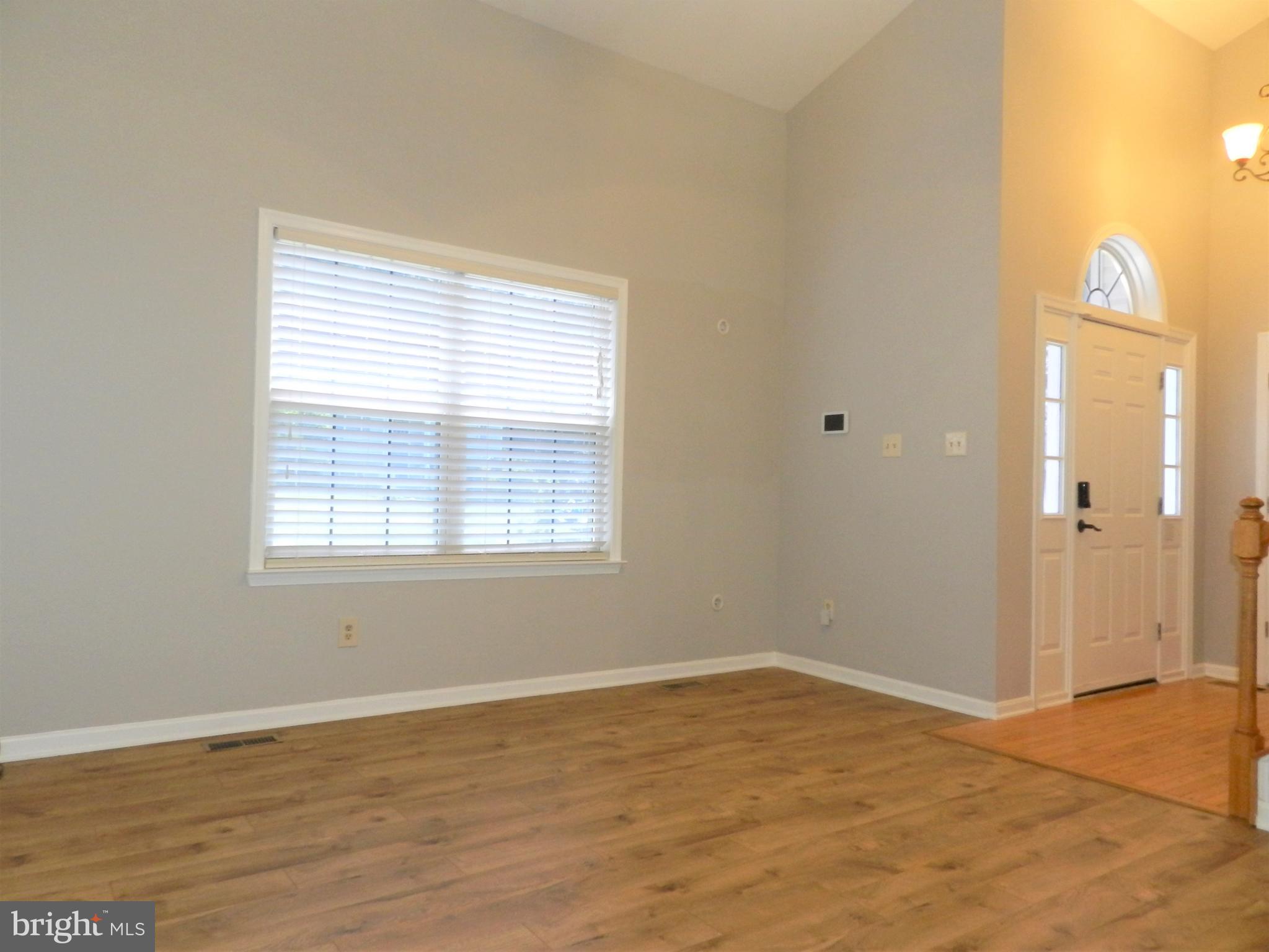 8650 Passapatanzy Road King George, VA 22485 - Photo 4 of 30 a view of an empty room with wooden floor and a window