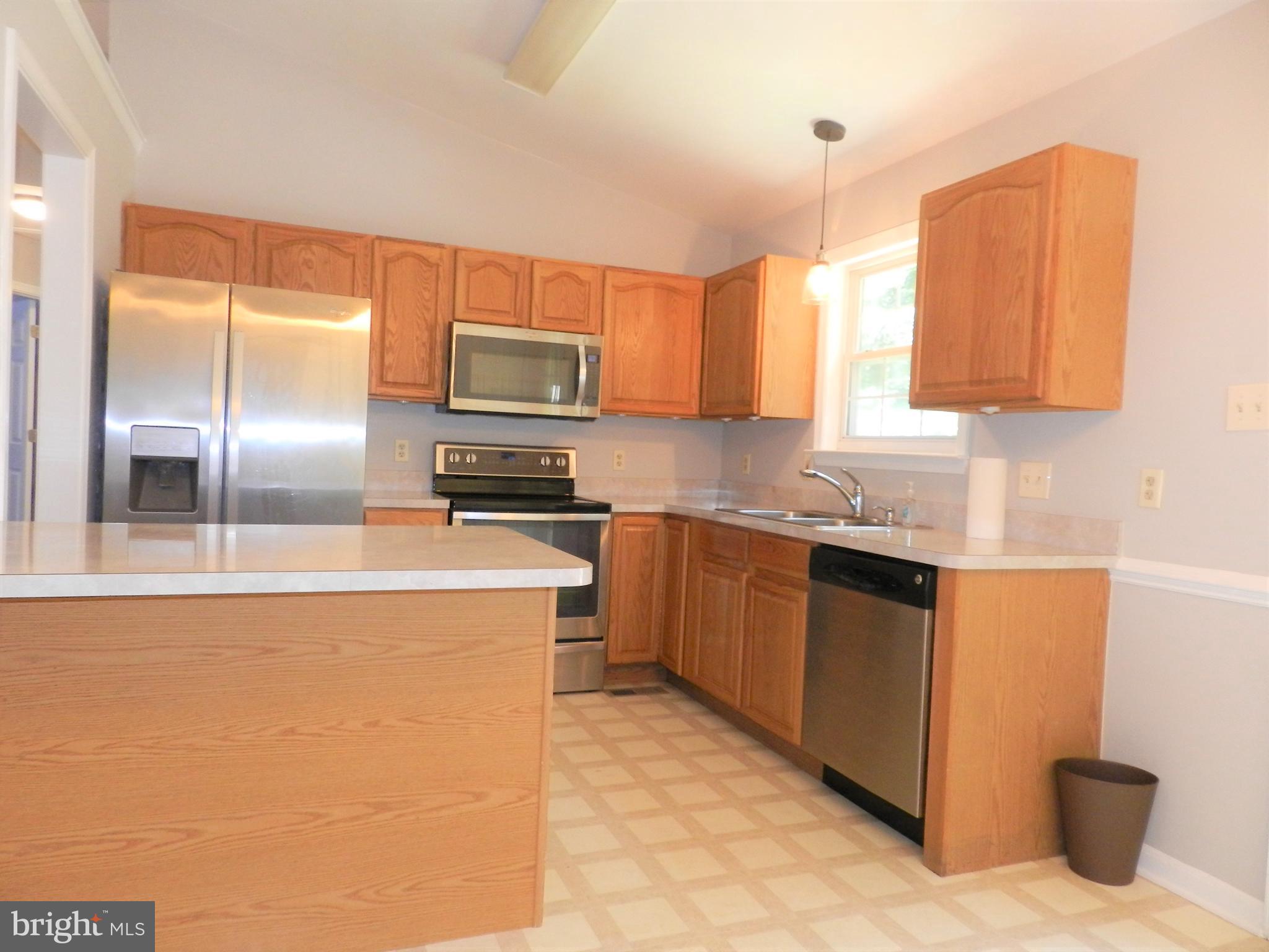 8650 Passapatanzy Road King George, VA 22485 - Photo 7 of 30 a kitchen with stainless steel appliances granite countertop a refrigerator a stove and a sink