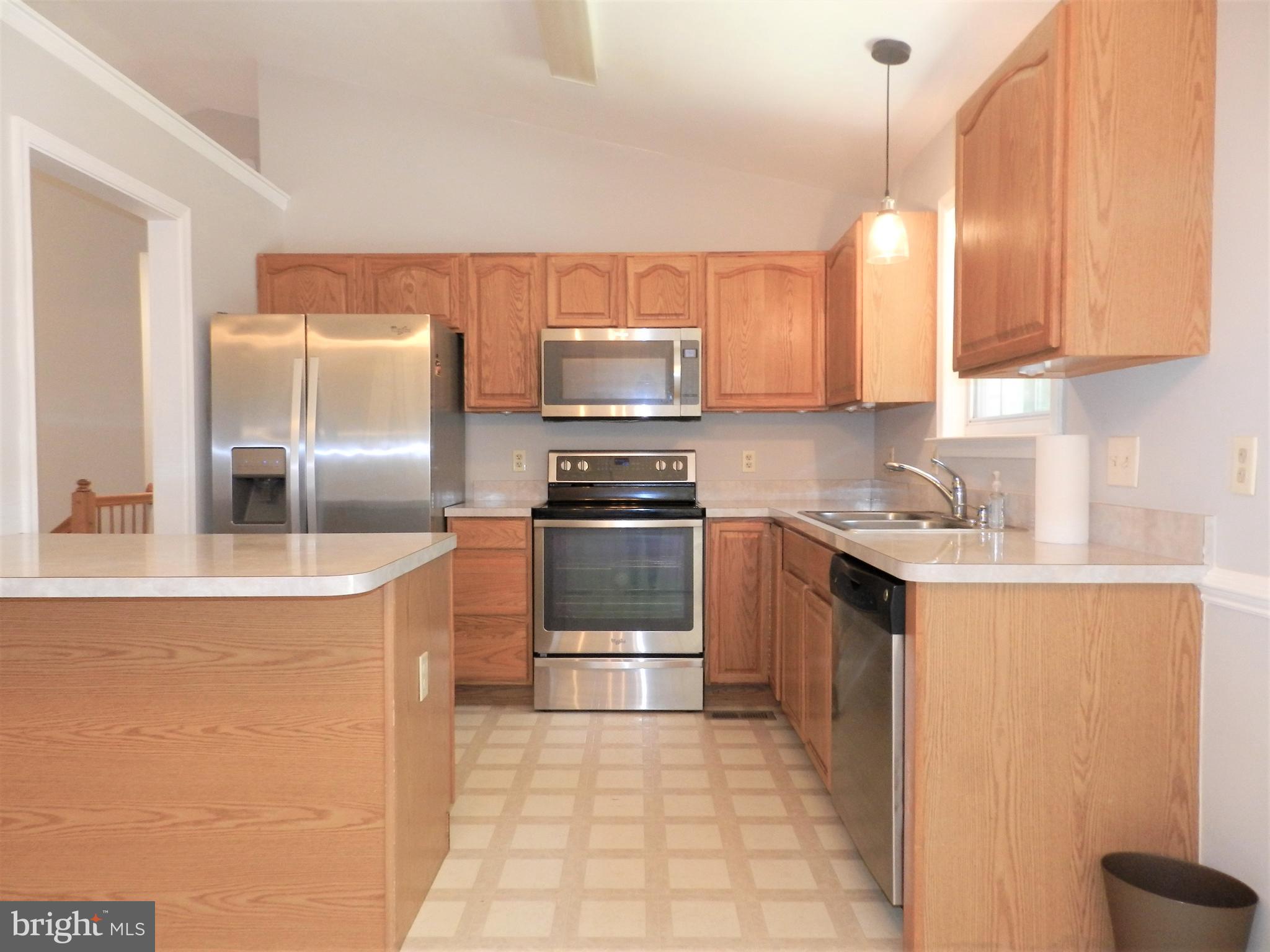 8650 Passapatanzy Road King George, VA 22485 - Photo 8 of 30 a kitchen with stainless steel appliances a stove a sink and a microwave