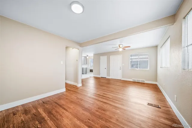a view of a kitchen with a sink and a refrigerator