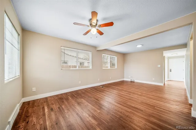 a view of empty room with wooden floor