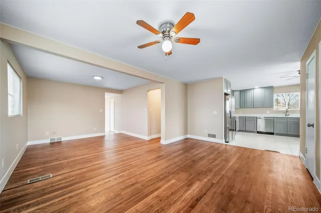 a living room with furniture and view of kitchen