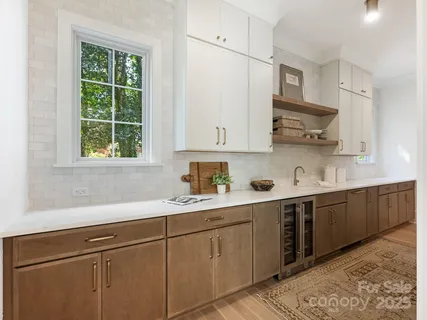 a kitchen with a sink cabinets and window