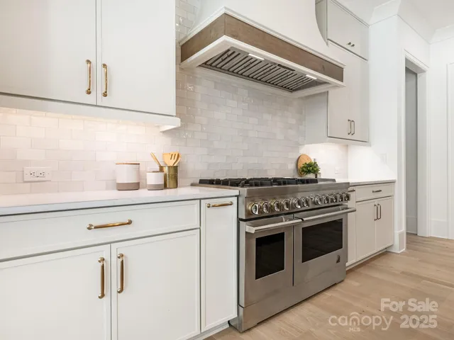 a kitchen with stainless steel appliances granite countertop a stove and a sink