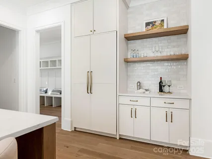 a kitchen with cabinets and wooden floor