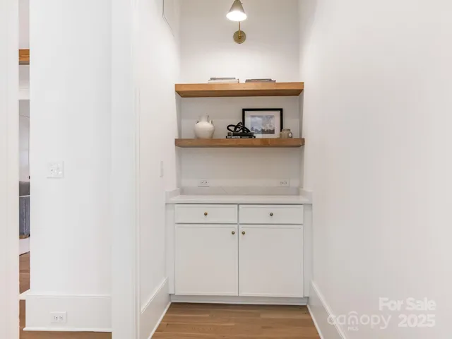 a spacious bedroom with a bed and glass window