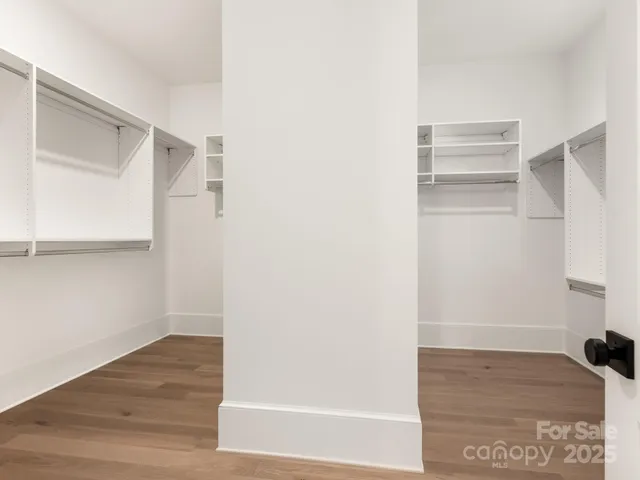 a view of walk in closet with empty racks