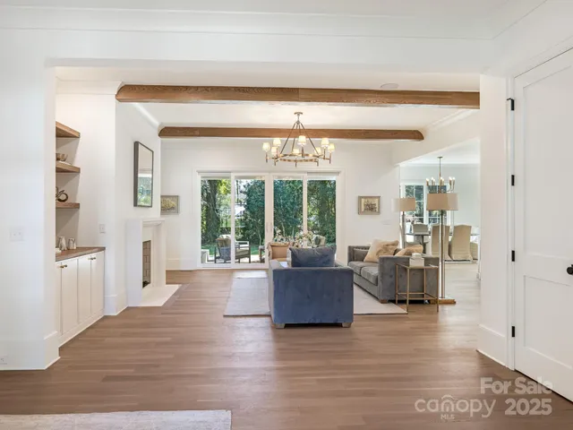 a living room with furniture and large windows