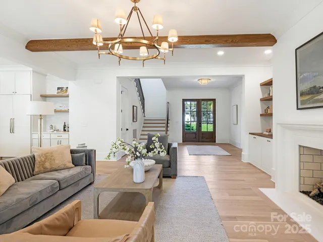 a living room with furniture and chandelier