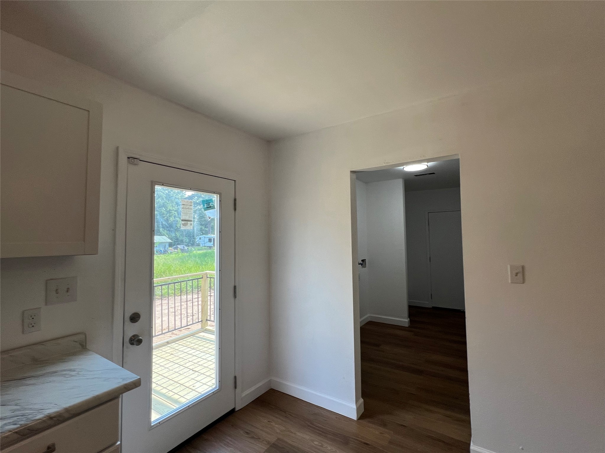 907 Daniel Street Cleveland, TX 77327 - Photo 24 of 45 Looking from Kitchen to Utility with a stairway exit and to the left back door