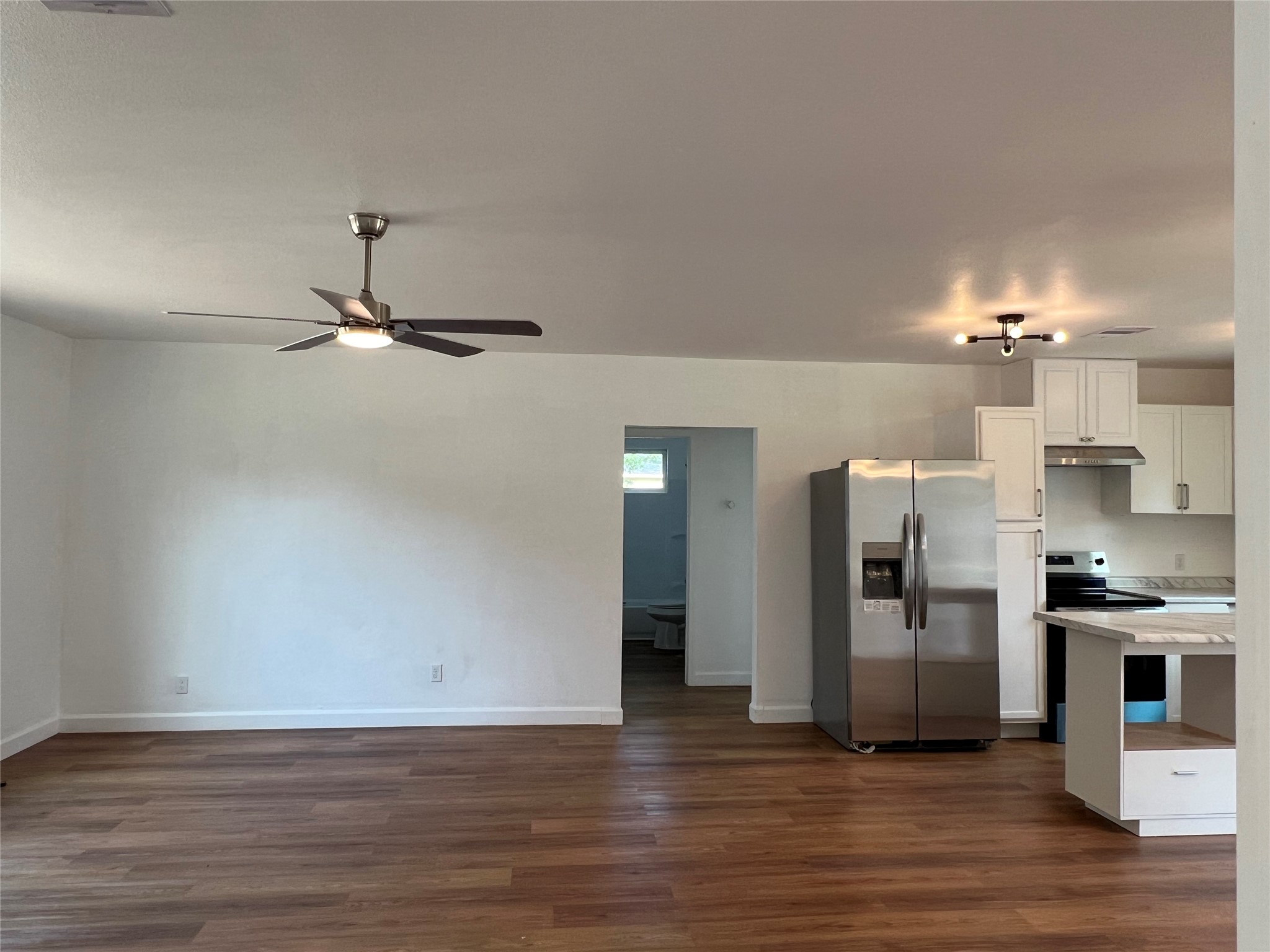 907 Daniel Street Cleveland, TX 77327 - Photo 36 of 45 Living room to doorway to the hall to two bed rooms
