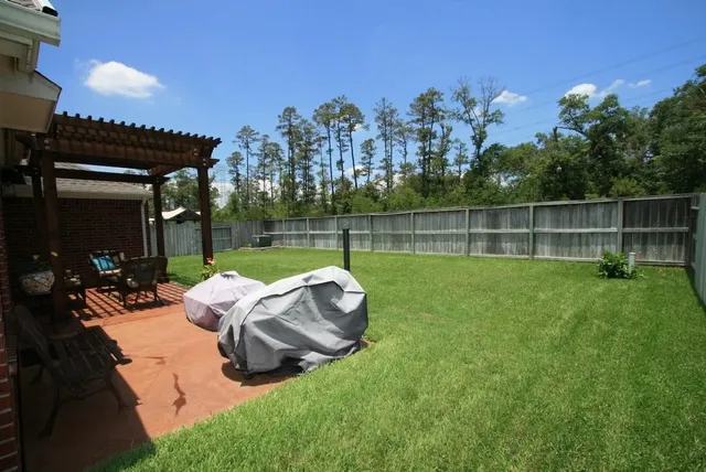 a view of a house with backyard and sitting area