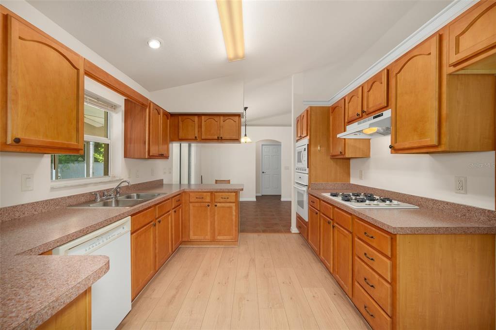 5090 Southeast 28th Street Ocala, FL 34480 - Photo 11 of 35 a kitchen with stainless steel appliances granite countertop a stove a sink and a refrigerator