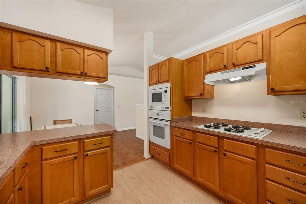 5090 Southeast 28th Street Ocala, FL 34480 - Photo 12 of 35 a kitchen with stainless steel appliances granite countertop a stove a sink and a refrigerator