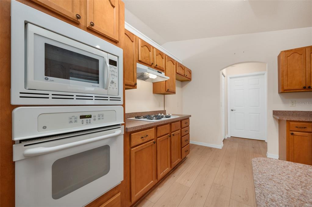 5090 Southeast 28th Street Ocala, FL 34480 - Photo 13 of 35 a kitchen with stainless steel appliances granite countertop a stove and a microwave