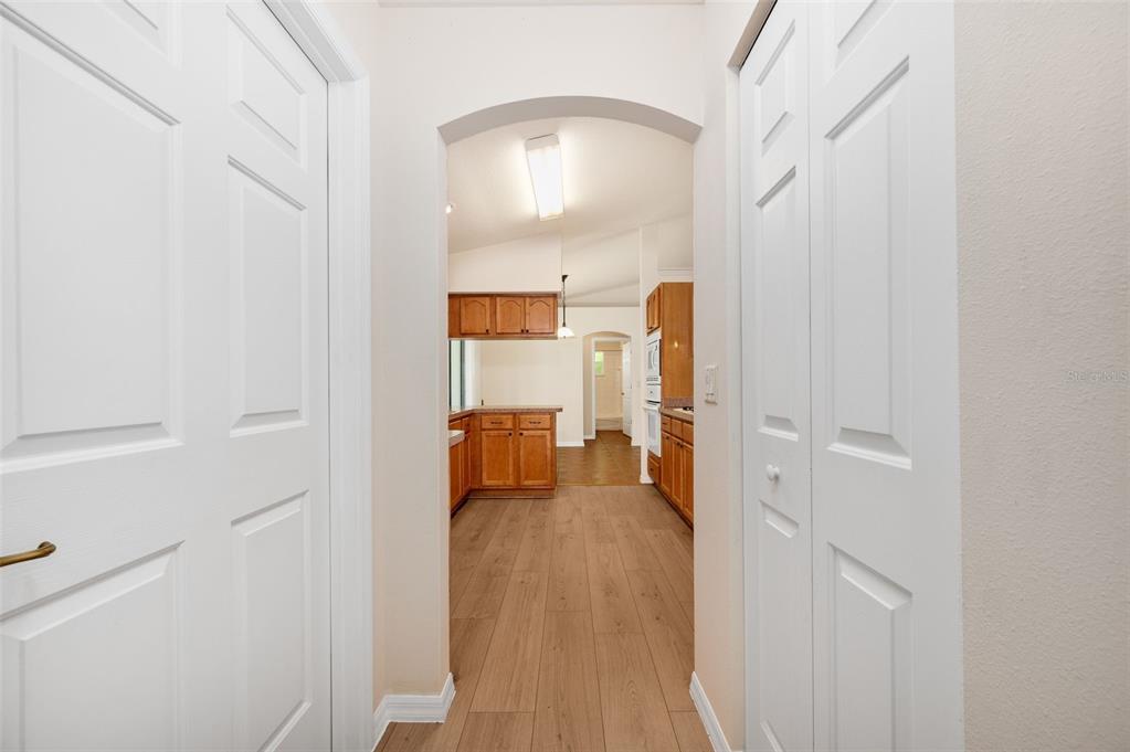 5090 Southeast 28th Street Ocala, FL 34480 - Photo 14 of 35 a view of a hallway with wooden floor and a living room